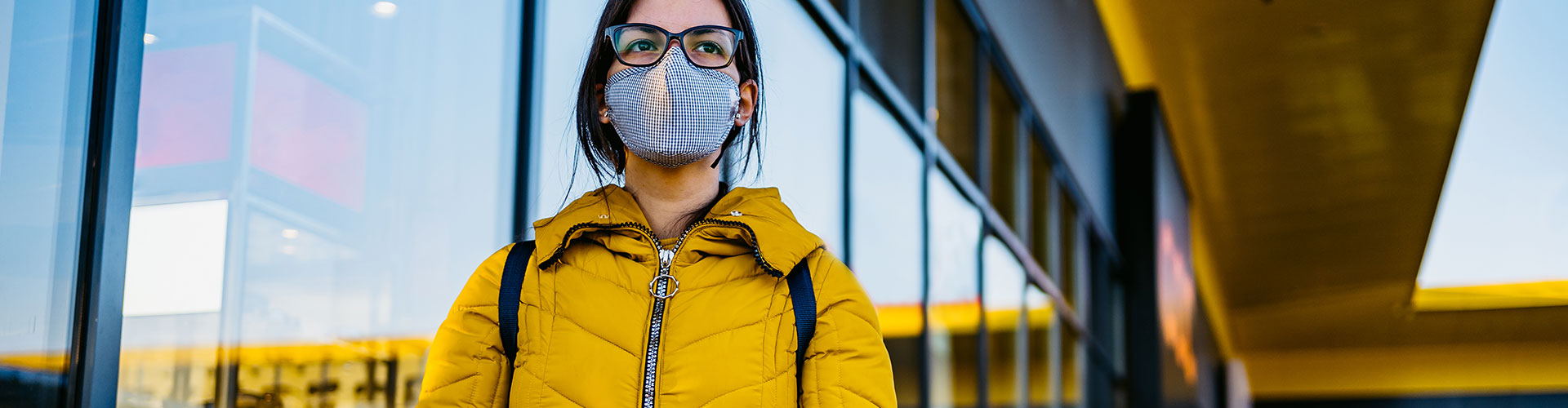 Webinar: How America Shops® In a COVID-19 Crisis blog banner featuring woman in mask and a yellow puffer jacket pushing a shopping cart
