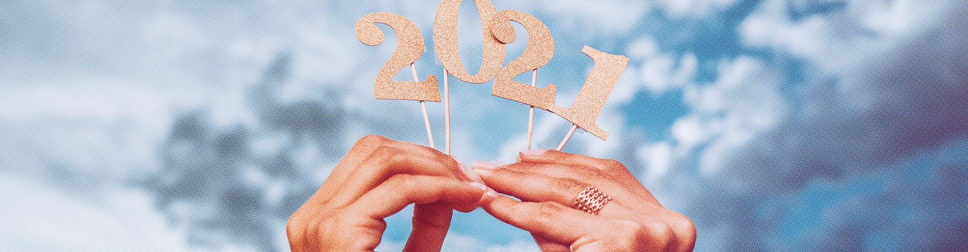 20 New Trends blog banner featuring hands holding glittery 2021 paper numbers