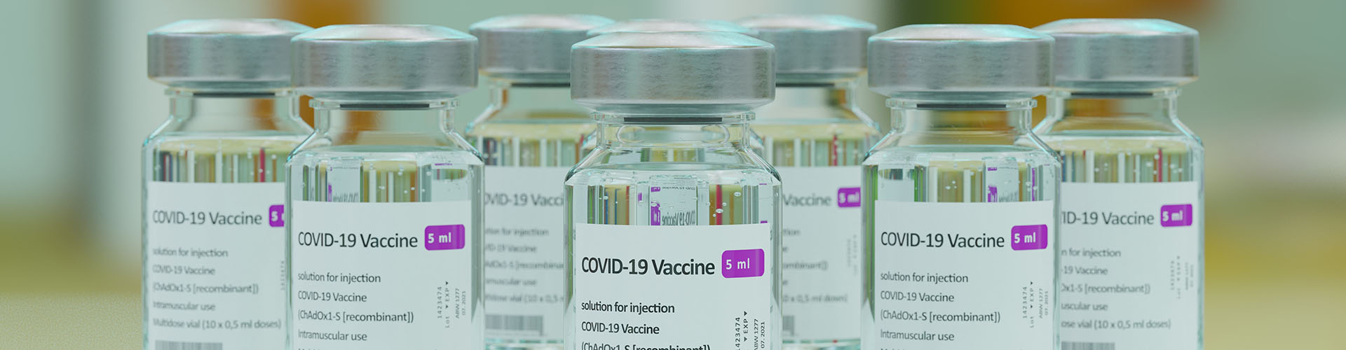 Banner featuring close up of a group of COVID vaccine glass vials