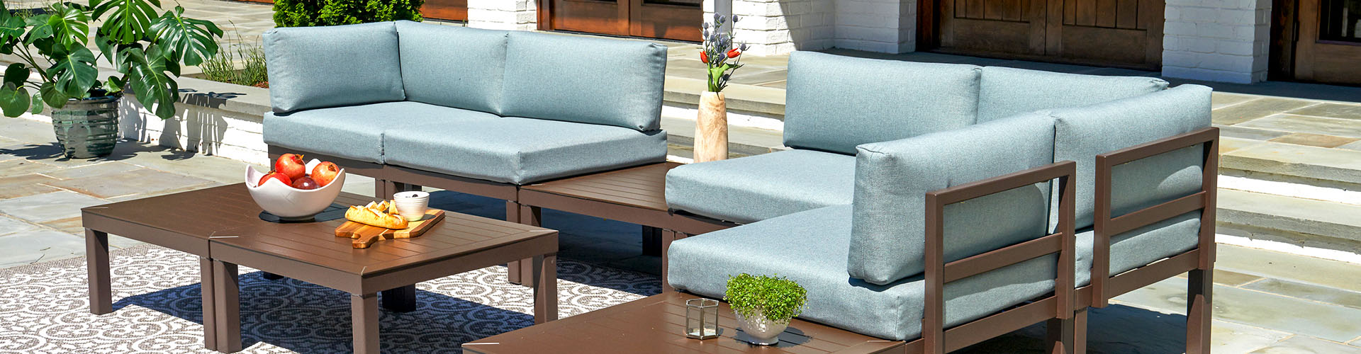 Banner featuring outdoor patio decorated with Telescope Casual brand furniture