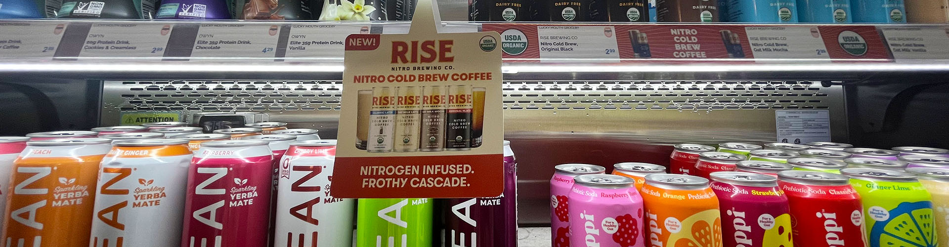 Banner featuring store fridge of diverse, beneficial coffee and carbonated beverage options