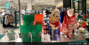 Photo of inside of Bloomie's featuring display cart with dogs clothing and treats