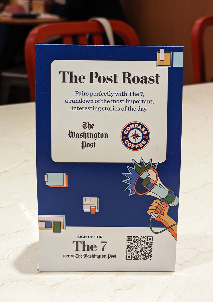 Top innovation photo of Compass Coffee's signage promoting stories to read from the Washington Post while you enjoy your drink