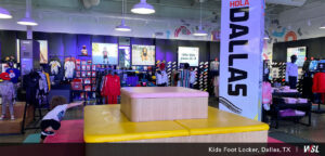 Photo of Kids Foot Locker play area in middle of store and kids clothing section in the background