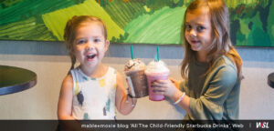 Photo of two young girls smiling with their Starbucks drinks