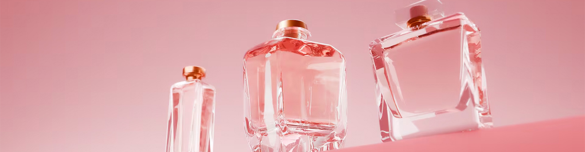 Gen-Z Fragrance Boom blog banner featuring three glass bottles of perfume on a pink background